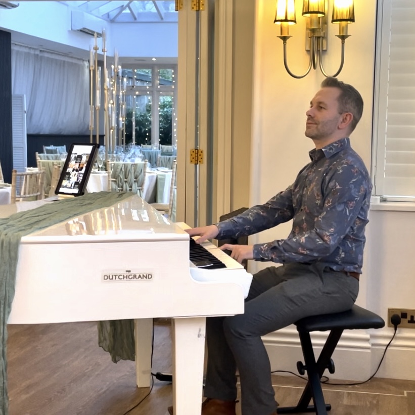 Broadoaks wedding pianist Craig Smith plays his white baby grand piano in the Orangery
