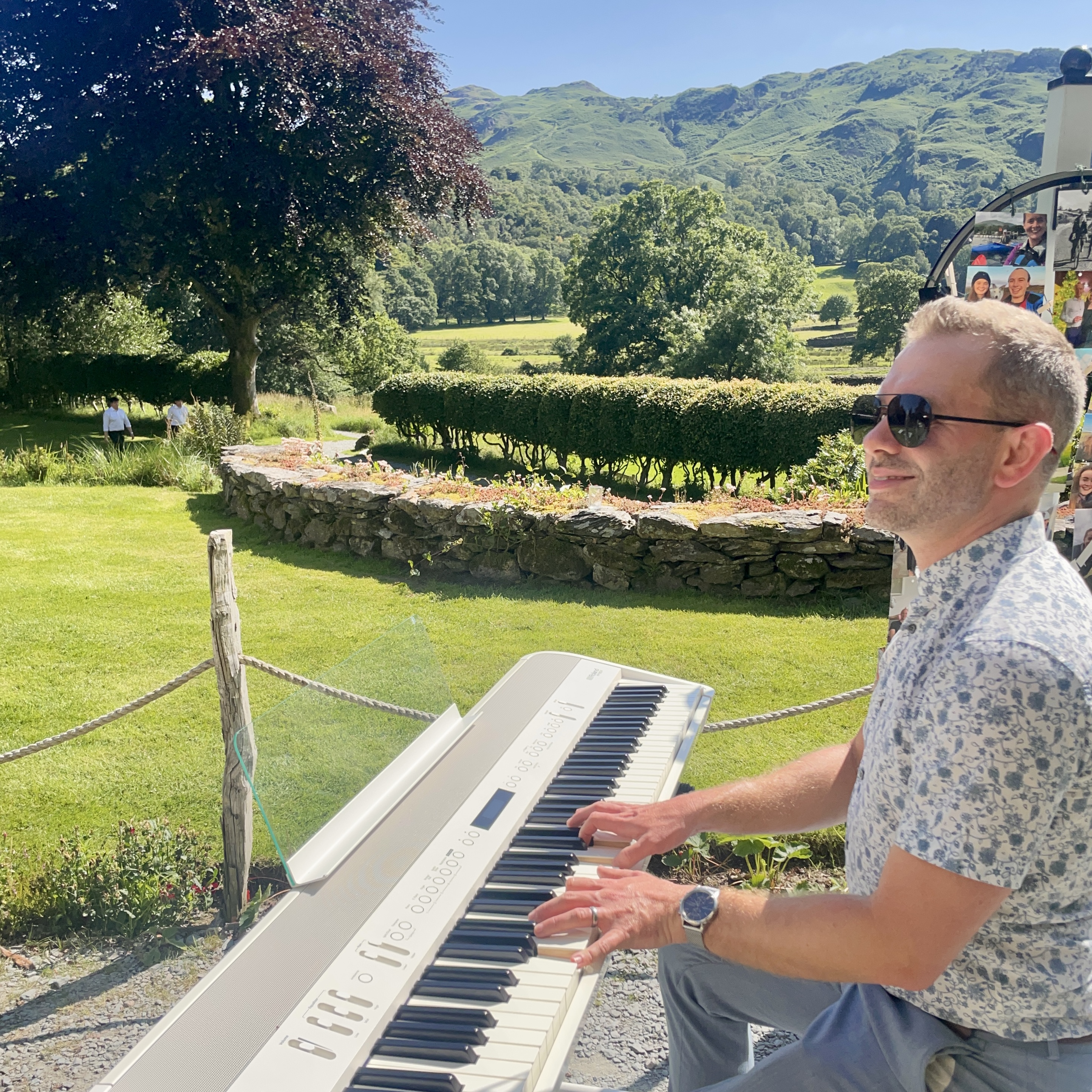 Outdoor wedding piano by Craig Smith during a sunny lancrigg drinks reception