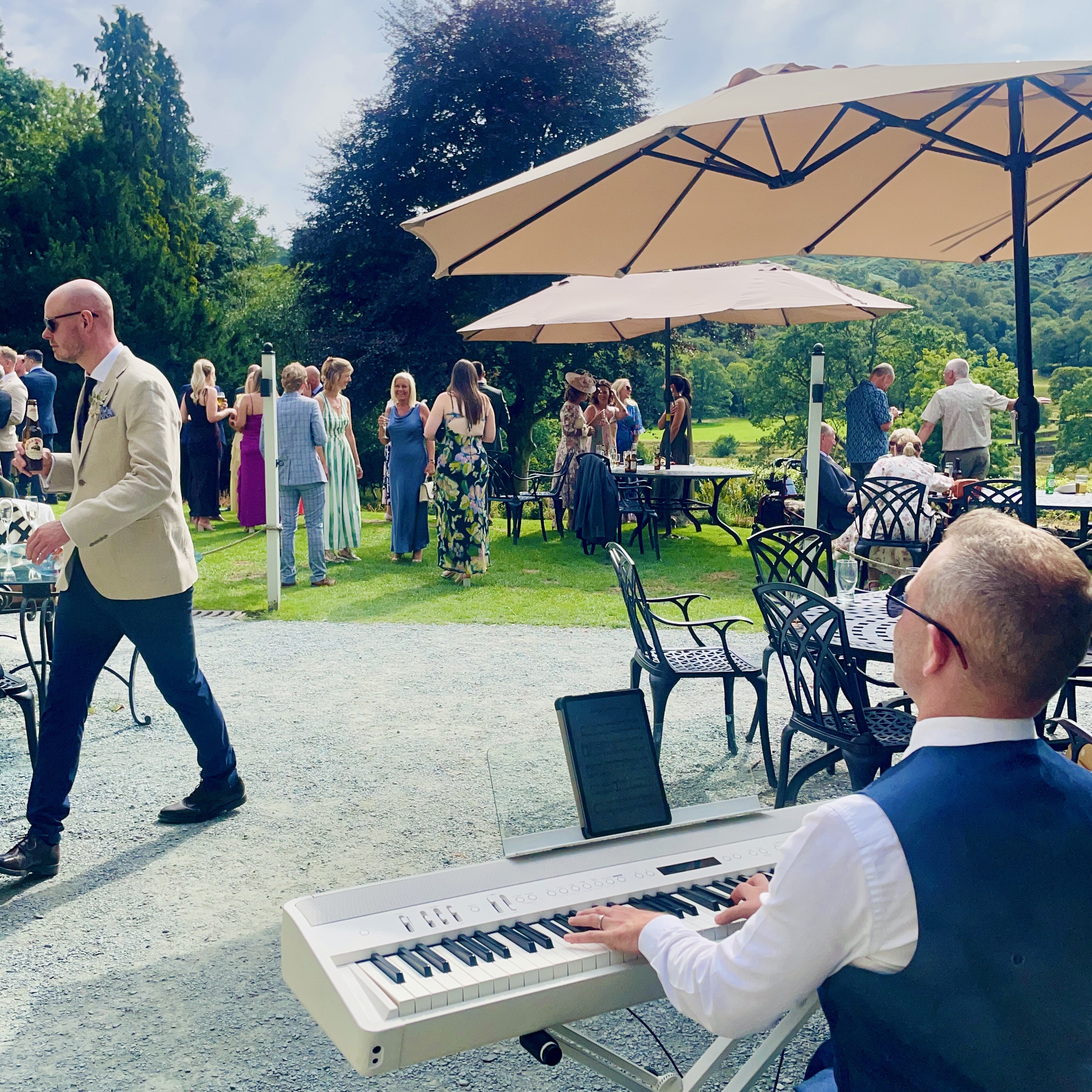 Outdoor wedding piano by Craig Smith during a sunny lancrigg drinks reception