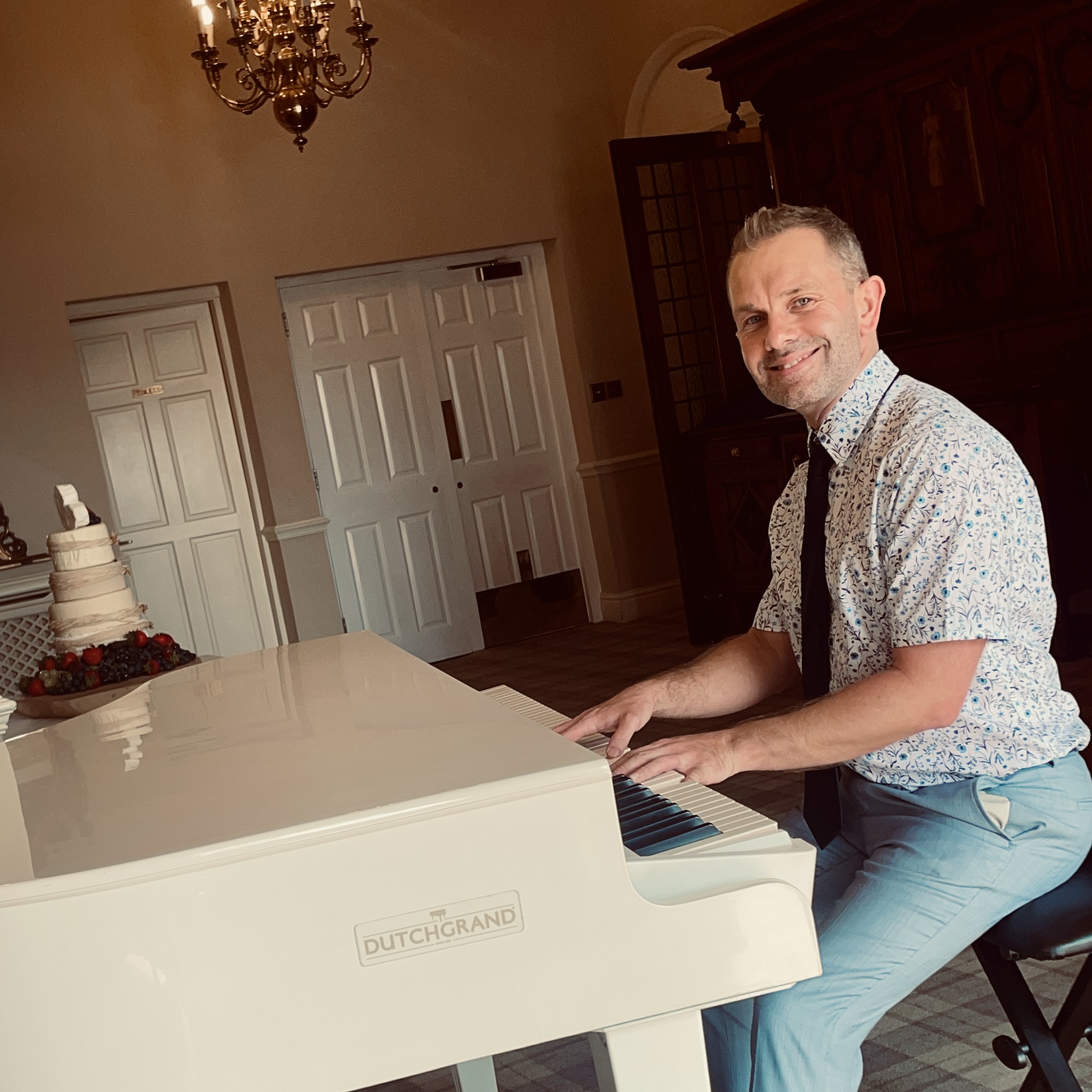 Recommended pianist Craig Smith plays his white baby grand piano for Merewood Country House wedding breakfast
