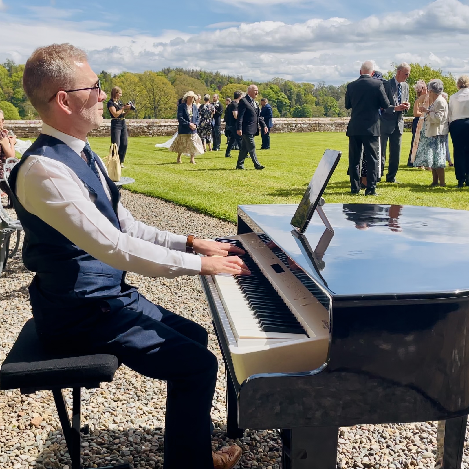 Wedding reception piano entertainment performed on the Rose Castle lawns by the Lake District Pianist Craig Smith