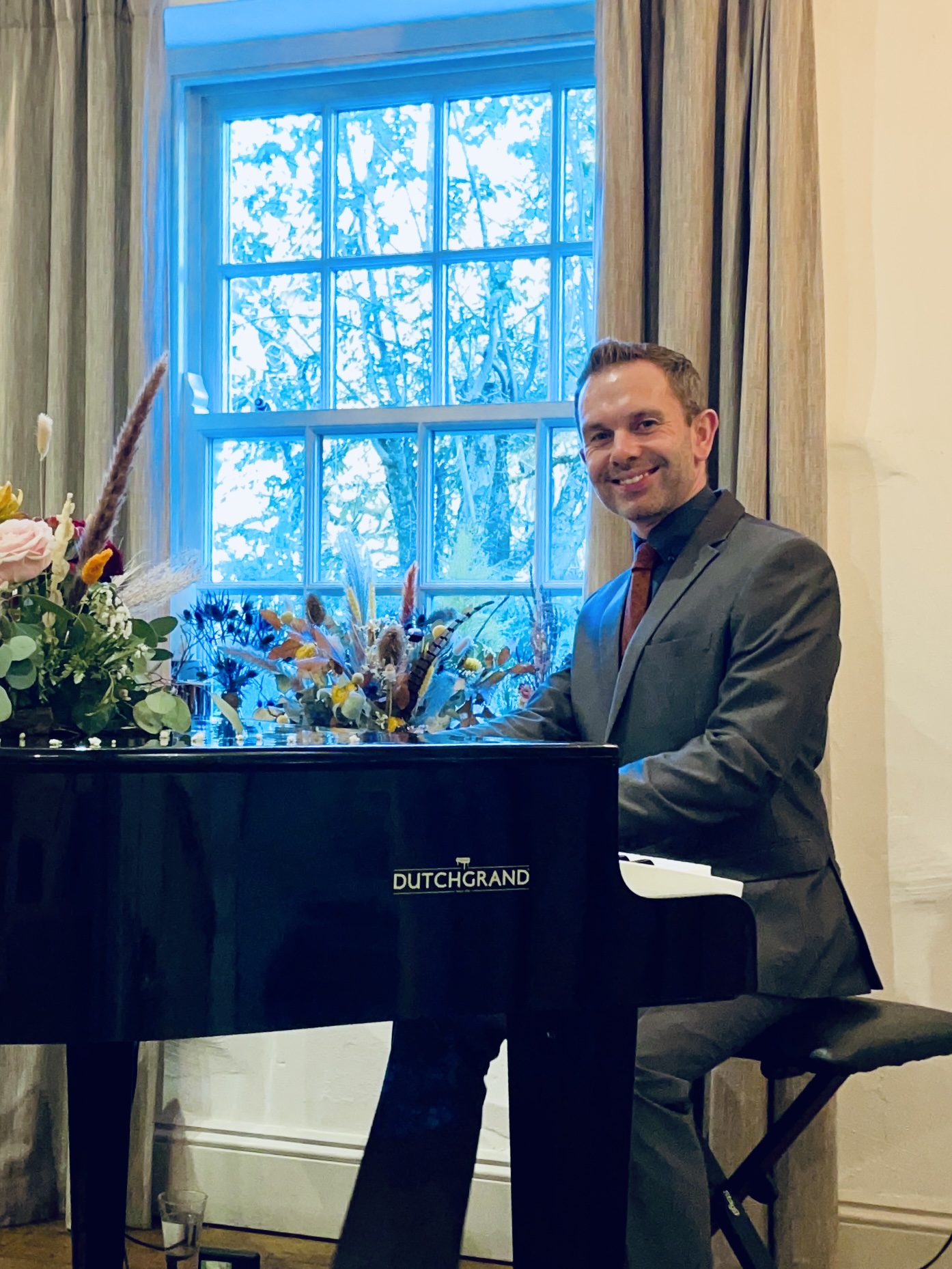 Wild Boar wedding pianist Craig Smith plays his black baby grand piano for a Wild Boar Estate wedding breakfast
