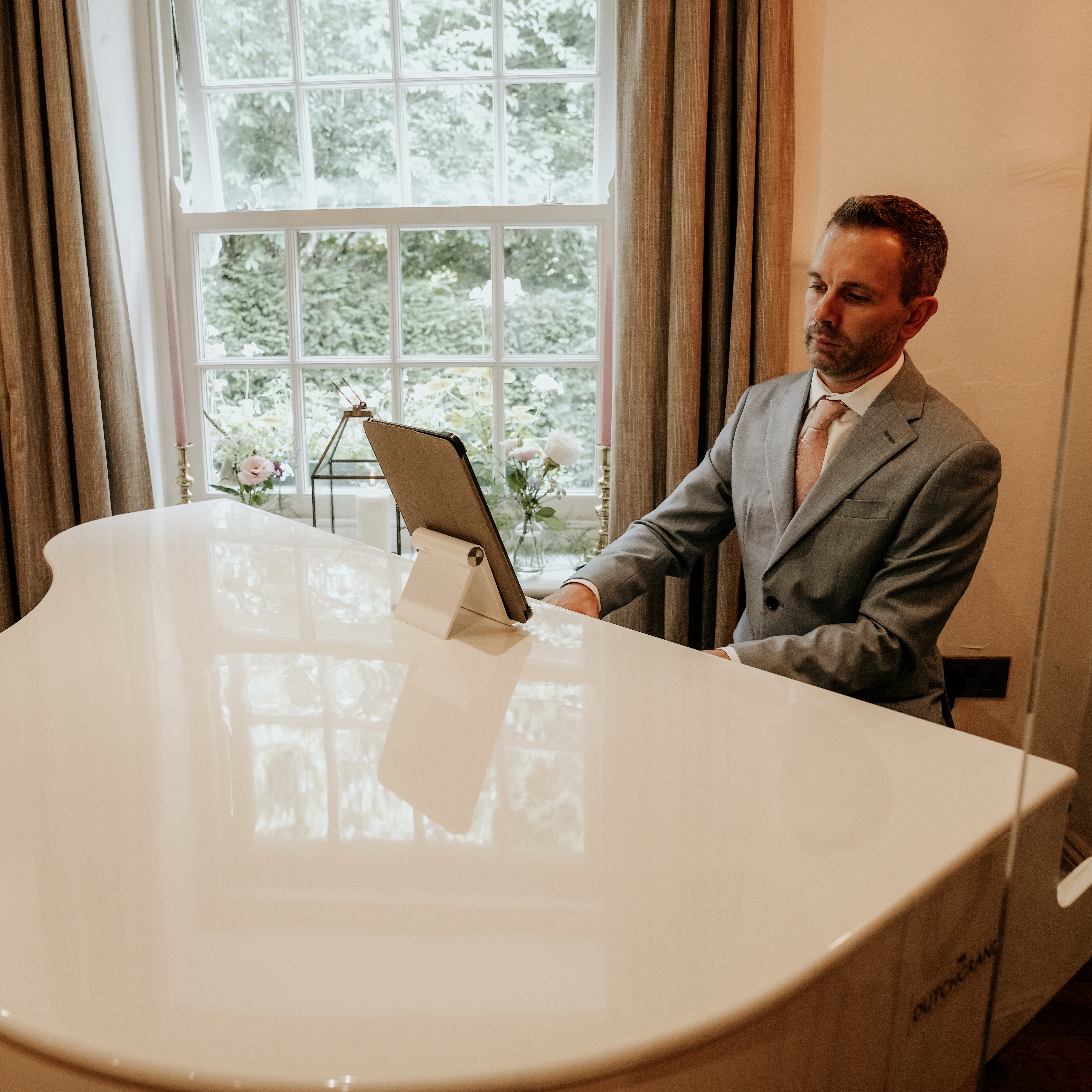 Wild Boar Estate wedding pianist Craig Smith plays his white baby grand piano for a wedding ceremony