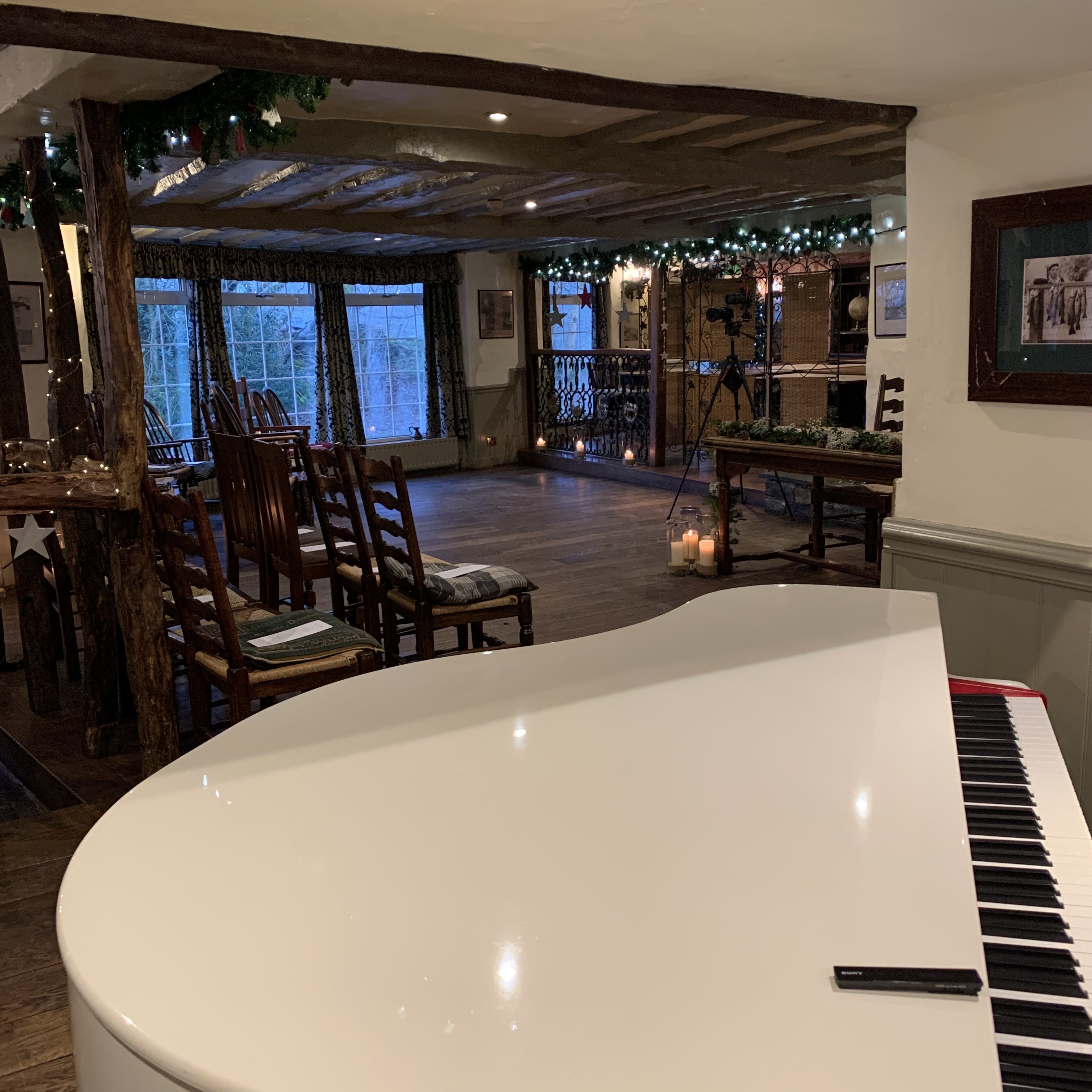 The Lake District Pianist's white baby grand piano set up ahead of a wedding ceremony at the Wild Boar Estate